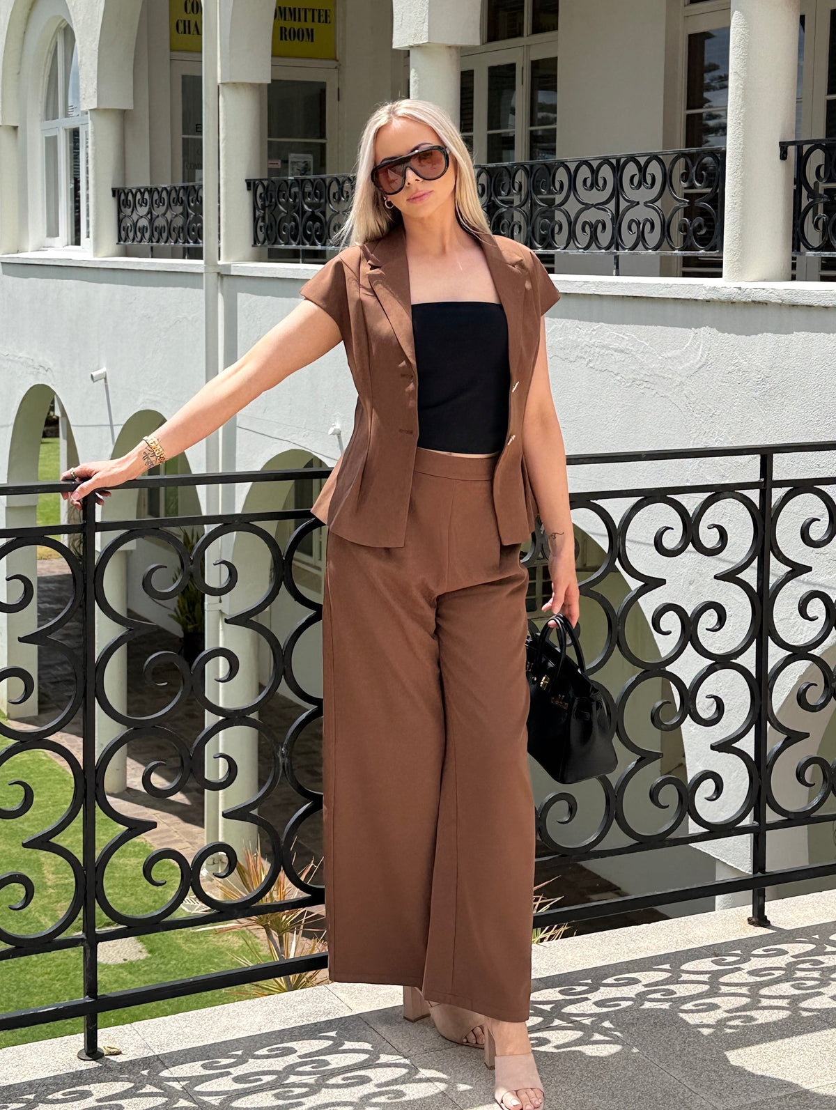 The Margaux set in chocolate: gold-button vest and wide leg trousers, full-length front view